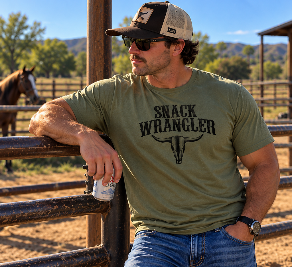 Man in military green Snack Wrangler tee at corral